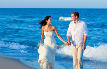 Mediterranean couple walking in blue beach