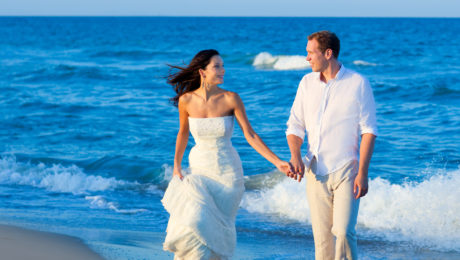 Mediterranean couple walking in blue beach